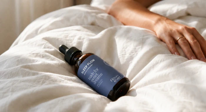Flowever Sleep Flow liquid sleep drops resting on soft white bedding