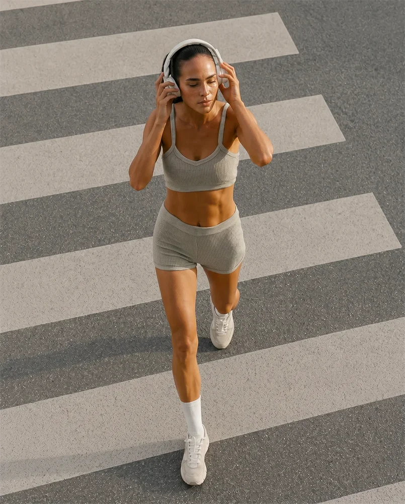 Woman running across a city crosswalk